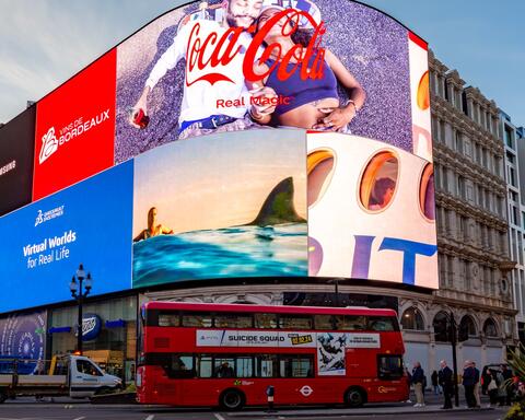 Photo of central London with brand logos behind red bus
